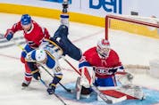 St. Louis Blues centre Brayden Schenn (10) is upended by Montreal Canadiens defenseman Brett Kulak (77) next to Montreal Canadiens goaltender Sam Montembeault (35) during third period in Montreal on Thursday, Feb. 17, 2022. 