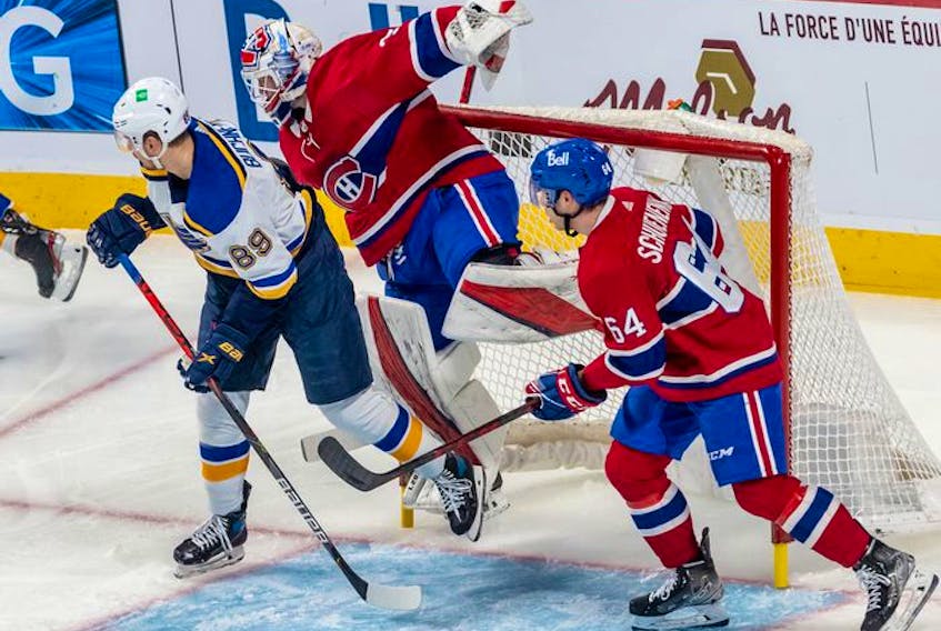 Montreal Canadiens goaltender Sam Montembeault (35) is checked into the net by St. Louis Blues left wing Pavel Buchnevich (89), knocking the net off its moorings during first period against the St. Louis Blues in Montreal on Thursday, Feb. 17, 2022. 