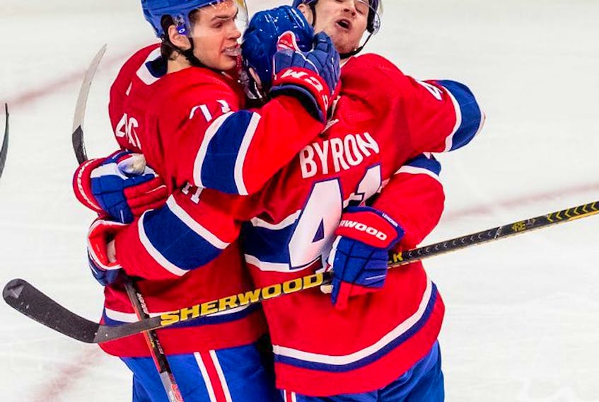 Montreal Canadiens left wing Paul Byron (41) is congratulated by teammates Jake Evans (71) and Artturi Lehkonen (62) during first period against the St. Louis Blues in Montreal on Thursday, Feb. 17, 2022. 