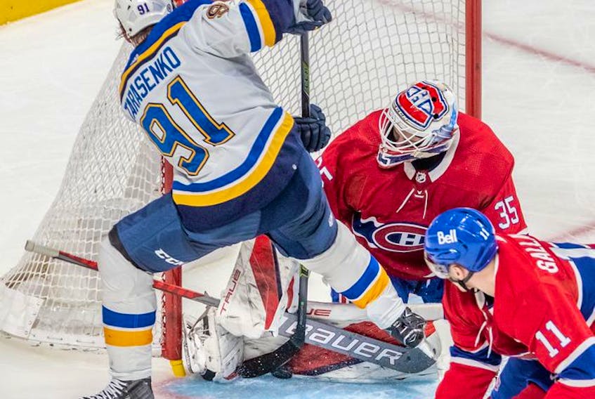 Montreal Canadiens goaltender Sam Montembeault (35) makes a pad save against St. Louis Blues right wing Vladimir Tarasenko (91) with Canadiens right wing Brendan Gallagher (11) looking on during second period in Montreal on Thursday, Feb. 17, 2022.