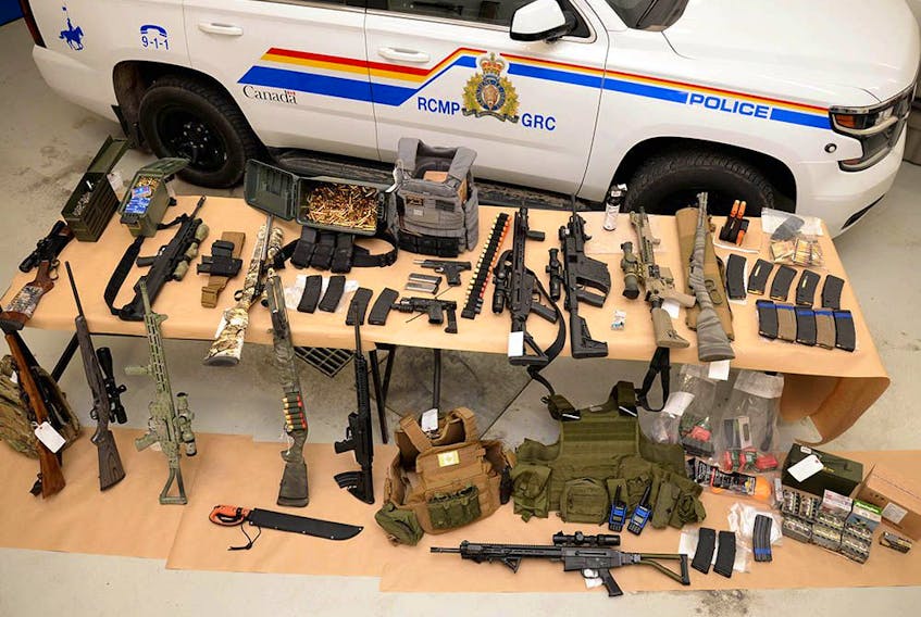  Photo supplied by RCMP on Monday, Feb. 14, 2022, shows a large assortment of weapons and ammunition seized near Coutts during a crackdown near the Canada/U.S. border.