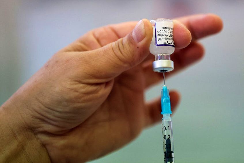  A health worker prepares a dose of the COVID-19 booster vaccine at Midland House in Derby, Britain, September 20, 2021