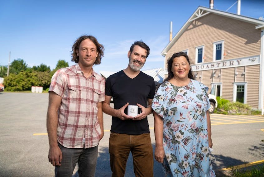 Dr. Gavin Fridell (centre), with Joey Pitoello and Vicki Matthews of Just Us! Coffee Roasters Co-op in Grand Pré, Nova Scotia. Just Us! serves as a community partner and case study for Fridell’s fair trade classes at Saint Mary’s University. CREDIT: Ian Selig.