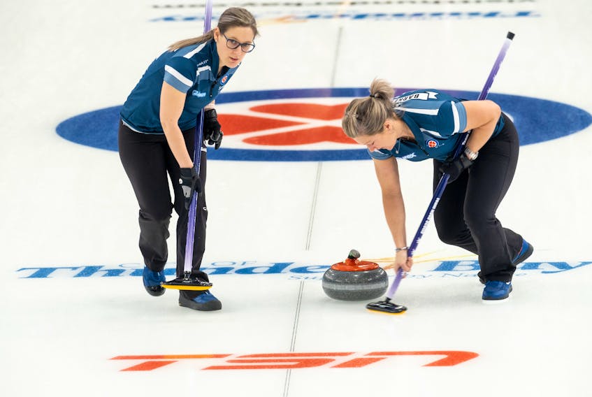 Nova Scotia third Jenn Baxter, left, and lead Shelley Barker sweep a rock during action at the Scotties Tournament of Hearts in Thunder Bay. - Andrew Klaver/Curling Canada