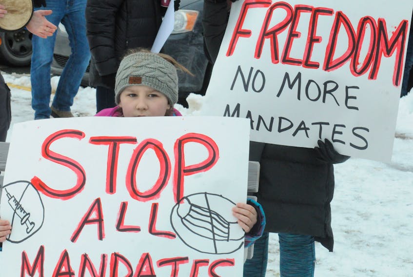 Carrying placards with varying messages, rally-goers in St. John's on Jan. 29 show their support to truckers gathered in the Ottawa protesting against the Liberal government’s vaccine  mandates for cross-border truckers.     
