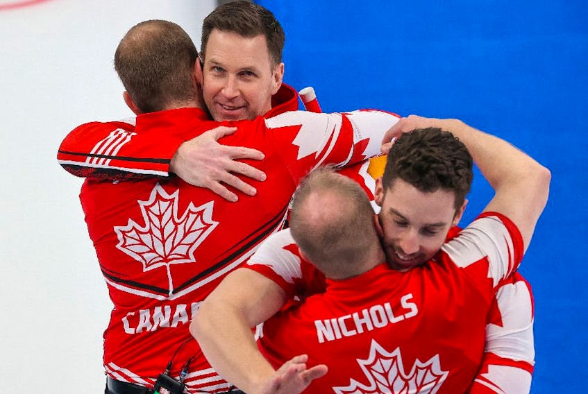  Team Canada celebrates after defeating the USA to win the bronze medal in men’s curling at the Beijing 2022 Winter Olympics on Friday, February 18, 2022.
