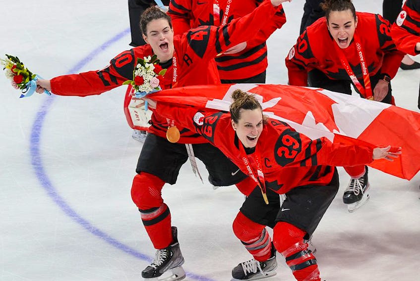 Team Canada celebrates with their gold medals after downing the USA 3-2 in women’s hockey at the Beijing 2022 Winter Olympics.