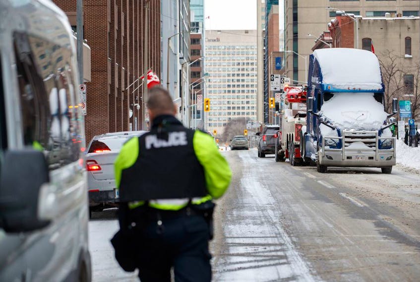 A truck is towed away in downtown Ottawa on Sunday, Feb. 20, 2022, after police worked to clear a trucker protest that was aimed at COVID-19 measures that grew into a broader anti-government protest. THE CANADIAN PRESS/Cole Burston ORG XMIT: CLB111_2022022018