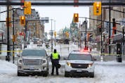  A Canadian police officer stands guard, as police work to evict the last of the trucks and supporters occupying the downtown core, three weeks after a protest against coronavirus disease (COVID-19) vaccine mandates began, near Parliament Hill in Ottawa, Ontario, Canada, February 20, 2022.