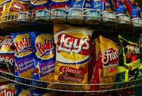 Snack food giant Frito Lay Canada announced February 24, 2004 that it is eliminating trans fat from it's favorite potato chip brands. To remove trans fat, the company will replace hydrogenated oils with corn oil. Frito Lays snacks are seen in a Montreal grocery store, February 24, 2004. REUTERS/Shaun Best  SB