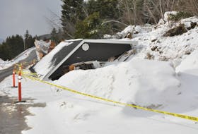The section of the main road through Irishtown-Summerside around Katie and Larry Warren’s home remains open to one lane of traffic after the couple’s garage was pushed down onto the road in a landslide on Feb. 17.