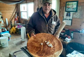 Danny Paul holds the waltes game he crafted, believed to be the largest in the world, at his home in Membertou. Paul plans to keep his unique spin on the traditional Mi'kmaw game: "It's the only one of its kind in existence — it's like owning the Mona Lisa." ARDELLE REYNOLDS/CAPE BRETON POST