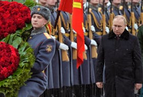 Russian President Vladimir Putin, who recognized the independence of two Moscow-backed rebel regions in Ukraine on Monday, takes part in a wreath laying ceremony at the Tomb of the Unknown Soldier by the Kremlin Wall on the Defender of the Fatherland Day in Moscow, Russia on Wednesday. Sputnik/Aleksey Nikolskyi/Kremlin via REUTERS