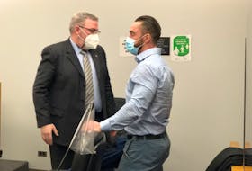 Noel Strapp (right) is shown with defence lawyer Ian Patey in provincial court in St. John's Feb. 15, 2022, shortly after Judge Phyllis Harris found Strapp guilty of sexually assaulting and exploiting a student.