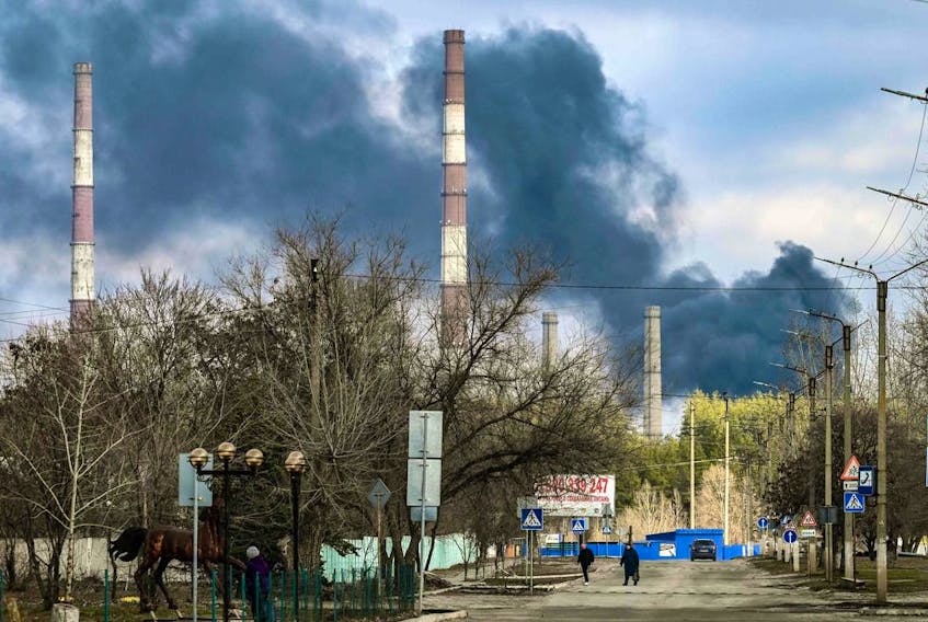  Smoke rises from a power plant after shelling outside the town of Schastia, near the eastern Ukraine city of Lugansk, on February 22, 2022. (Photo by ARIS MESSINIS/AFP via Getty Images)