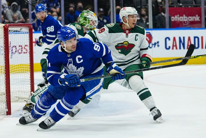 Maple Leafs' John Tavares (left) and Minnesota Wild's Jared Spurgeon battle for position during the third period at Scotiabank Arena on Thursday, Feb. 24, 2022. 