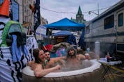  Demonstrators sit in a hot tub on Wellington during a protest that shut down the street and much of the downtown for several weeks.