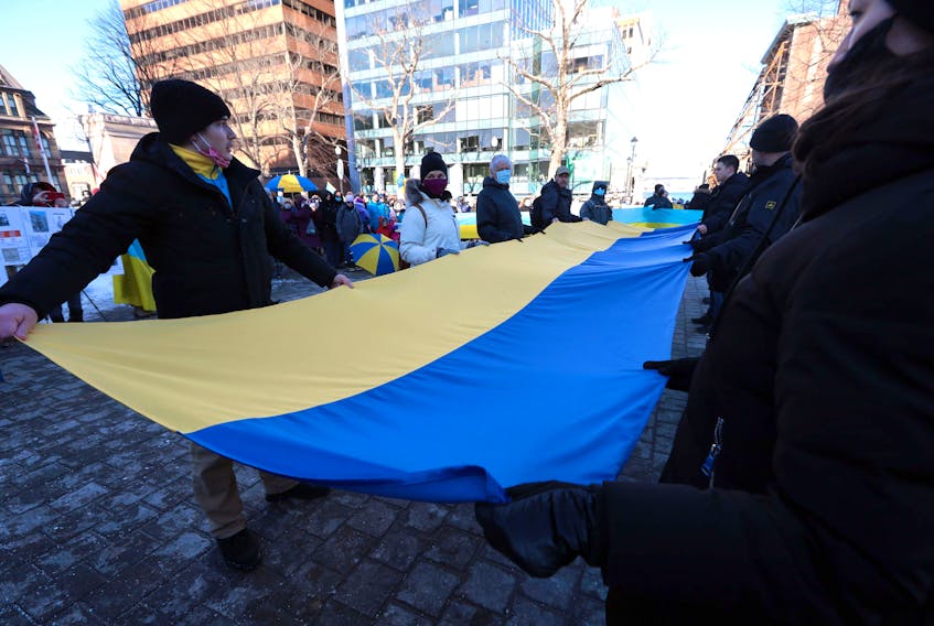 Feb. 26, 2022--A large Ukrainian flag is unrolled during a rally in the Grand Parade in Halifax Saturday. The show of support for Ukraine in front of Halifax City Hall called for peace in Ukraine as Russia continues its invasion.  The Nova Scotia government is donating $100,000 to the Canada-Ukraine Foundation to provide humanitarian aid and support to the people of Ukraine.
ERIC WYNNE/Chronicle Herald