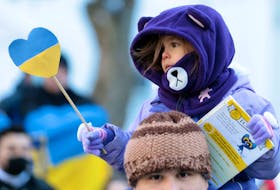 Feb. 26, 2022--A little girl holding the colours of the Ukrainian flag is held aloft by her father during a rally in the Grand Parade in Halifax Saturday. The show of support for Ukraine in front of Halifax City Hall called for peace in Ukraine as Russia continues its invasion.  The Nova Scotia government is donating $100,000 to the Canada-Ukraine Foundation to provide humanitarian aid and support to the people of Ukraine.
ERIC WYNNE/Chronicle Herald