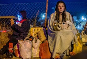  Helena. right. and her brother Bodia from Lviv are seen at the Medyka pedestrian border crossing, in eastern Poland on Feb. 26, 2022, following the Russian invasion of Ukraine.