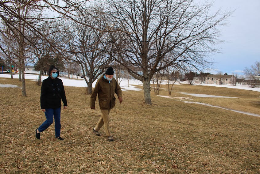 Anna Johnstone and Bob MacLeod walk through municipal parkland on Brophy Street in Summerside. The city is considering selling part of the property to a local developer for the construction of four apartment buildings. Both Johnstone and MacLeod live nearby and are concerned about the deal. 