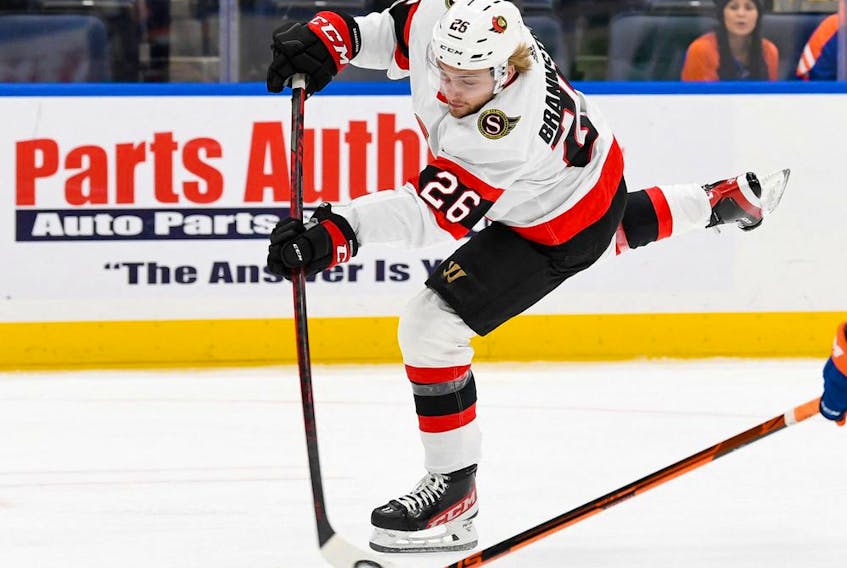 Ottawa Senators defenceman Erik Brannstrom (26) attempts a shot against the New York Islanders during the first period at UBS Arena, Feb. 1, 2022.