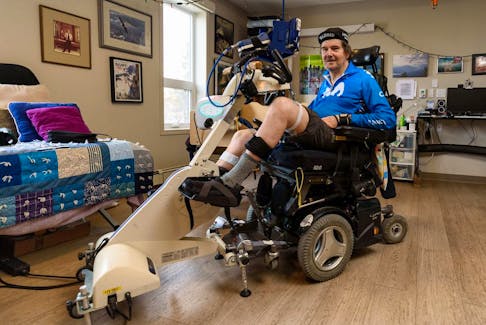  Stewart Midwinter pedals on his stationery bike at his room in Inclusio accessible housing in Calgary to virtually ride around the world.