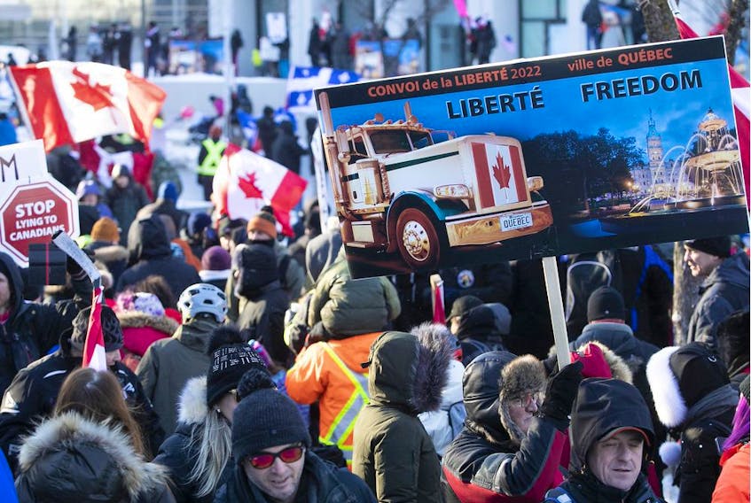 MONTREAL, QUE.: FEBRUARY 5, 2022 --  Signs carried along by protesters on Grande Allee next to Quebec's National Assembly during massive protest against COVID-19 vaccine and health restrictions on Saturday February 5, 2022. (Pierre Obendrauf / MONTREAL GAZETTE) ORG XMIT: 67360 - 1257