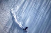  TOPSHOT – A skier practices for upcoming womens giant slalom final during the Beijing 2022 Winter Olympic Games at the Yanqing National Alpine Skiing Centre in Yanqing on February 6, 2022. (Photo by Dimitar DILKOFF / AFP)