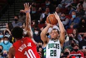 Milwaukee Bucks guard Lindell Wigginton goes up for a shot against Dennis Smith Jr. of the Portland Trail Blazers during an NBA game on Saturday. - Milwaukee Bucks
