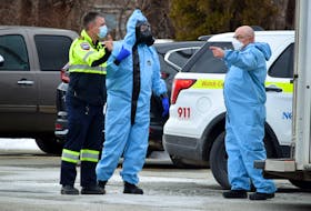 Hazmat team members talks with EHS while on scene at the Barrington Municipal Administrative Centre on Feb. 7  to retrieve a suspicious package suspected to contain a chemical irritant from South Shore St. Margaret’s MP Rick Perkins’ office. KATHY JOHNSON