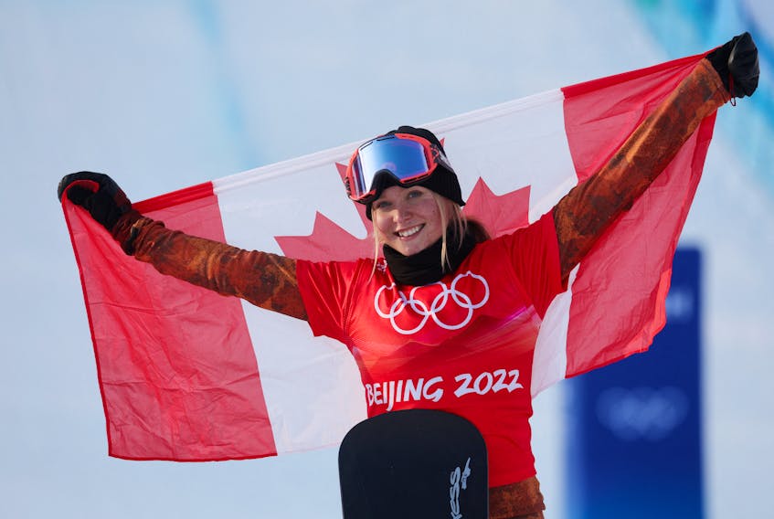 Meryeta Odine of Canada celebrates during the flower ceremony after winning the bronze medal in the women's snowboard cross at Genting Snow Park, Zhangjiakou, China, on Wed. Feb. 9, 2022, during the Beijing Olympics.