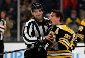 Boston Bruins’   Brad Marchand   is held back by linesman Andrew Smith   after he got a penalty for attempting to injure Pittsburgh Penguins goalie Tristian Jarry during the third period of an NHL game on Tuesday night. Winslow Townson-USA TODAY Sports