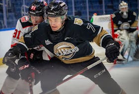 Charlottetown Islanders defenceman Oscar Plandowski, 7, and Quebec Remparts forward Nathan Gaucher battle for position in a Quebec Major Junior Hockey League game in Quebec City on Feb. 8. The Islanders won the contest 4-0. Jonathan Roy Photo/Courtesy of Quebec Remparts