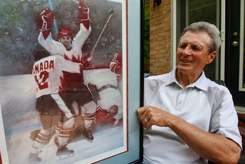 Legendary Team Canada 1972 Summit Series hero Paul Henderson poses with a print of "The Goal" in his Mississauga backyard. 