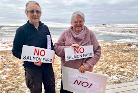 Yarmouth County residents Anna Mallin and Sue Hutchins hold some of the 'No Salmon Farm' signs that have been seen around Yarmouth County since last year. They are pleased with a decision by the Municipality of Yarmouth to deny a recent application but say more clarity continues to be needed moving forward. TINA COMEAU PHOTO