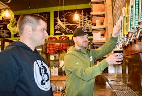 These are the guys who started Breton Brewing in 2015. This file photograph shows Andrew Morrow drawing a pint under the watchful eye of business partner Bryan MacDonald at the company’s Keltic Drive location. CAPE BRETON POST FILE PHOTO