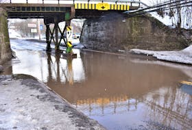 Water build-up under the train bridge, as well as a large pothole hidden by the water, forced the closure of a section of Main Street in Bible Hill.