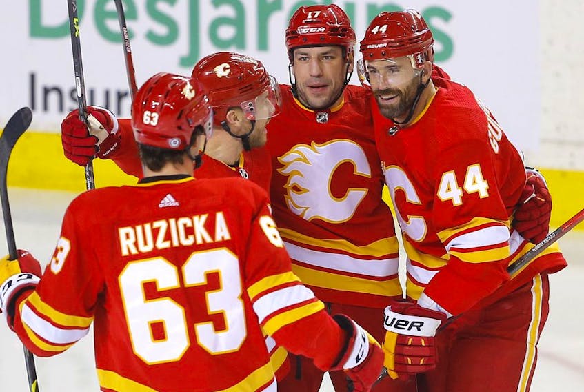 Calgary Flames defenceman Erik Gudbranson (right) celebrates with teammates after scoring a goal against the  Columbus Blue Jackets at Scotiabank Saddledome in Calgary on Feb. 15, 2022.