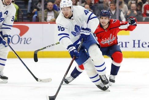 Feb 28, 2022; Washington, District of Columbia, USA; Toronto Maple Leafs defenseman Ilya Lyubushkin (46) skates with the puck as Washington Capitals left wing Conor Sheary (73) chases in the first period at Capital One Arena.  
