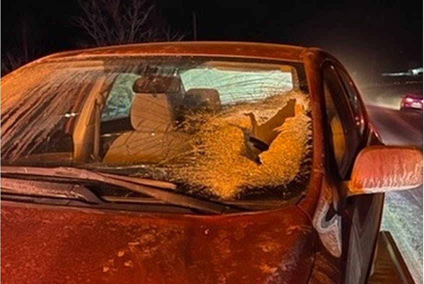 A woman was travelling eastbound on Highway 148 Monday night when a plate of ice from a truck travelling in the opposite direction crashed through her car's windshield, police said. 
