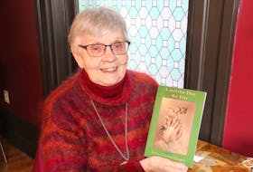 Jockie Loomer-Kruger holds a copy of her novel, Until the Day We Die.’ She has been writing since she was a child but this is her first novel. LYNN CURWIN PHOTO