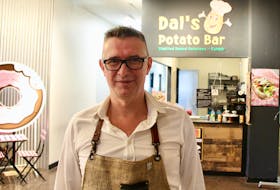 Ferhat Dal stands in front of his new business, Dal’s Potato Bar in Founders' Food Hall and Market in Charlottetown.