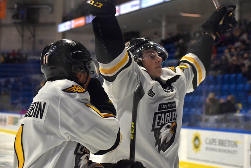 Cape Breton Eagles forward Cam Squires, right, lifts his arms in the air after scoring the second of three goals for his first career Quebec Major Junior Hockey League hat trick during action against the Chicoutimi Saguenéens at Centre 200 on Thursday. Cape Breton won the game 8-2. JEREMY FRASER/CAPE BRETON POST.