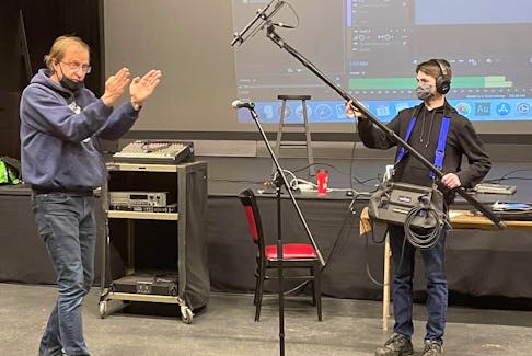 James Carrier, left, gives a lesson on sound technology with trainee Joseph Tardif during the Confederation Centre of the Arts' backstage training program.