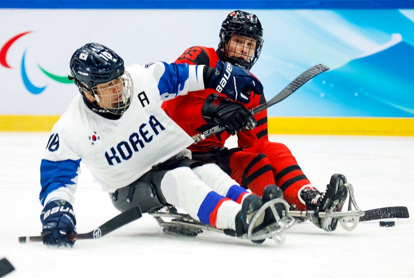 Liam Hickey (red) and his Team Canada teammates will be competing for a Paralympic gold medal Saturday night at the National Indoor Stadium in Beijing. To get there, Canada defeated South Korea 11-0. Hickey is shown here competing against Cho Young-jae of South Korea. REUTERS/Peter Cziborra