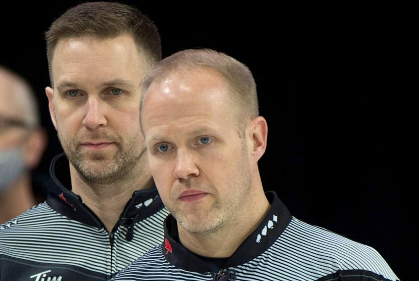 Mark Nichols and Brad Gushue at the 2022 Brier earlier this week in Lethbridge. On Friday, Nichols tested positive for COVID-19 and will miss the playoff round.