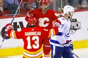 Calgary Flames forward Johnny Gaudreau celebrates his hat-trick goal against the Tampa Bay Lightning with Elias Lindholm at Scotiabank Saddledome in Calgary on Thursday, March 10, 2022. 