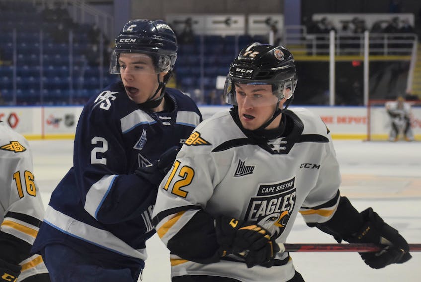 Sherbrooke Phoenix defenceman Christophe Rondeau, left, and Cape Breton Eagles forward Jack Campbell react to a play on the ice during a Québec Major Junior Hockey League match on Saturday evening at Centre 200 in Sydney. The Phoenix won the game 4-3 in overtime.