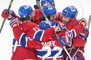  Canadiens’ Nick Suzuki, right, celebrates with teammates after scoring against the Seattle Kraken during third period NHL hockey action in Montreal on Saturday, March 12, 2022.